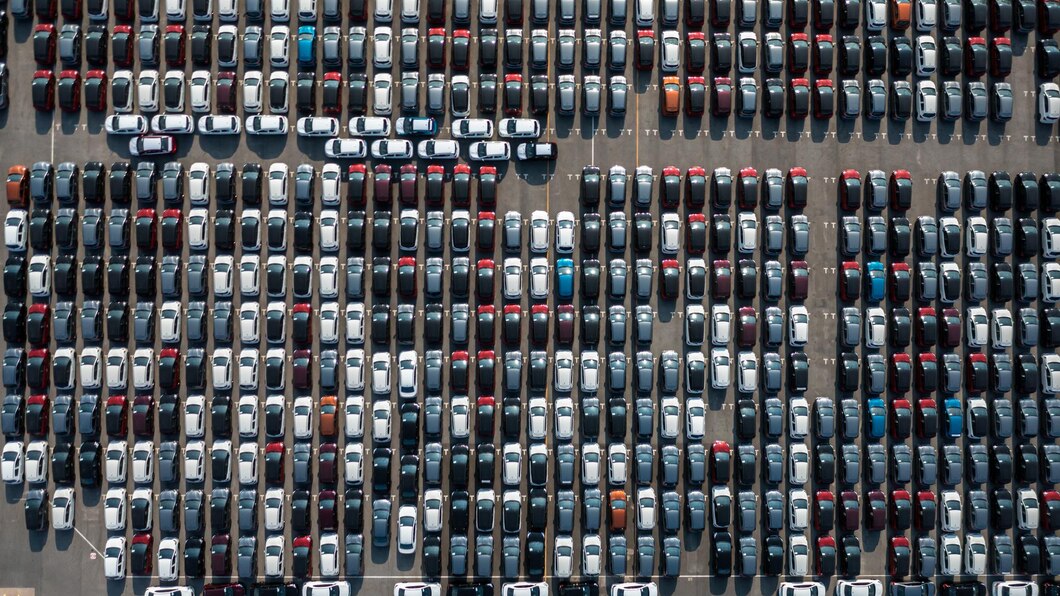 aerial-top-view-rows-new-cars-parked-distribution-center-car-factory-automobile-automotive-car-parking-lot-commercial-business-industry-dealership-sale_35024-1616